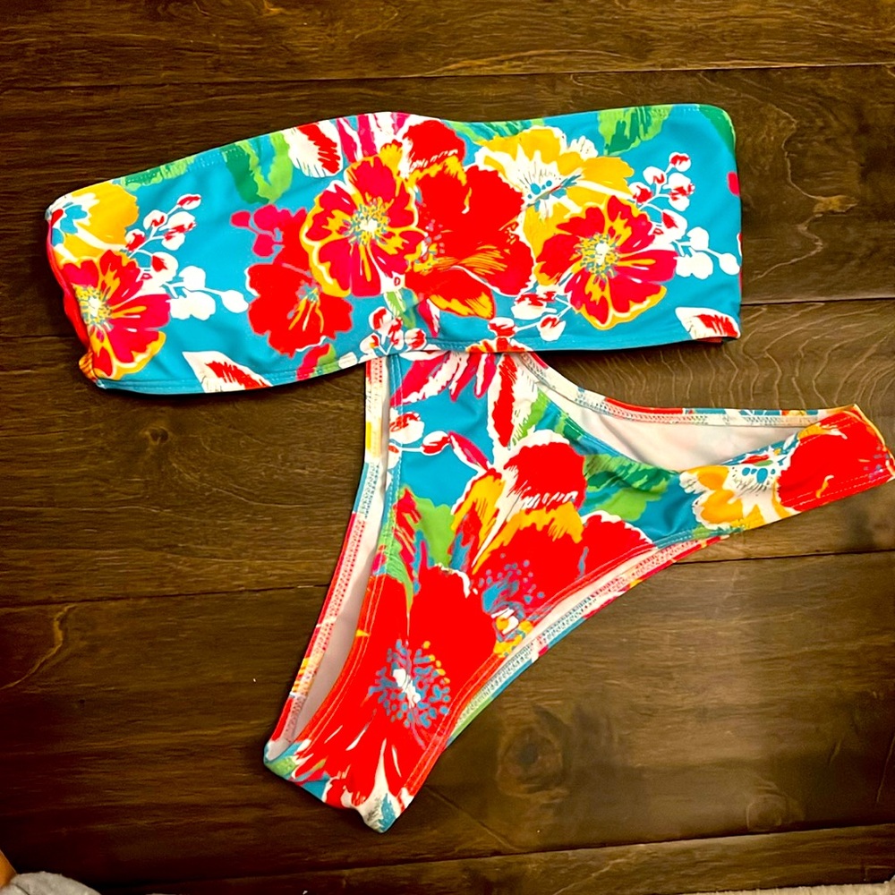 Size small bathing suit, never worn. Flowers all around in multiple colors